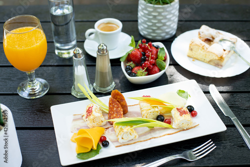 details of delicious outdoor brunch on black wooden table