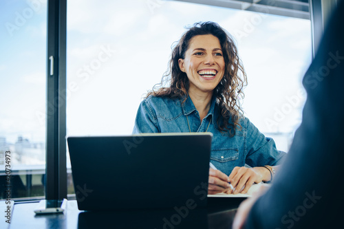 Businesswoman taking interview of a job applicant photo