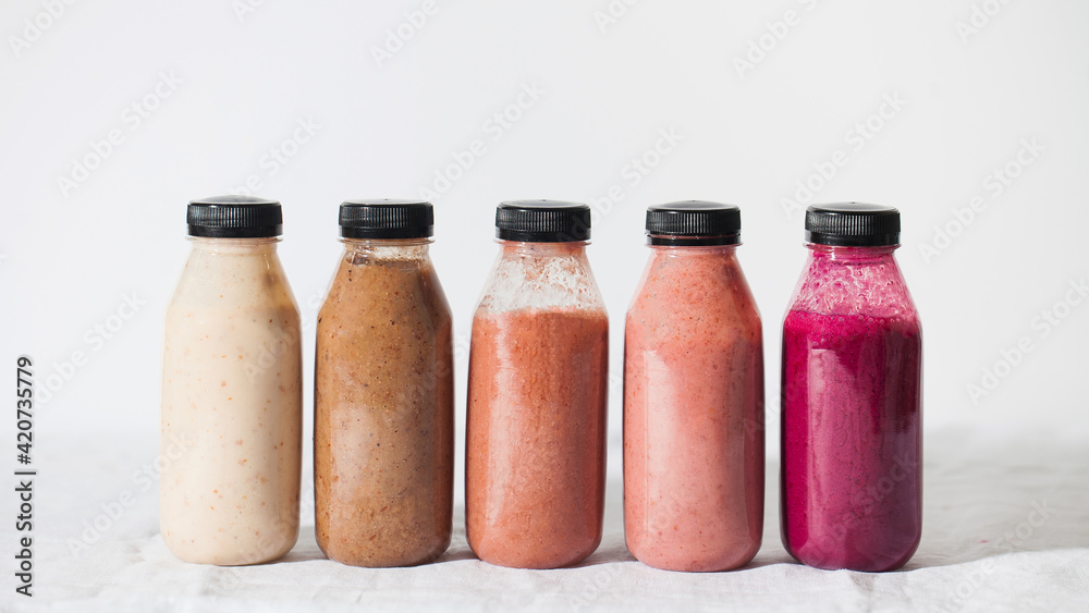 Fruit and vegetable smoothies in bottles. Place for the logo. Copy space. Fruit and vegetable smoothies in bottles. Place for the logo. Copy space.