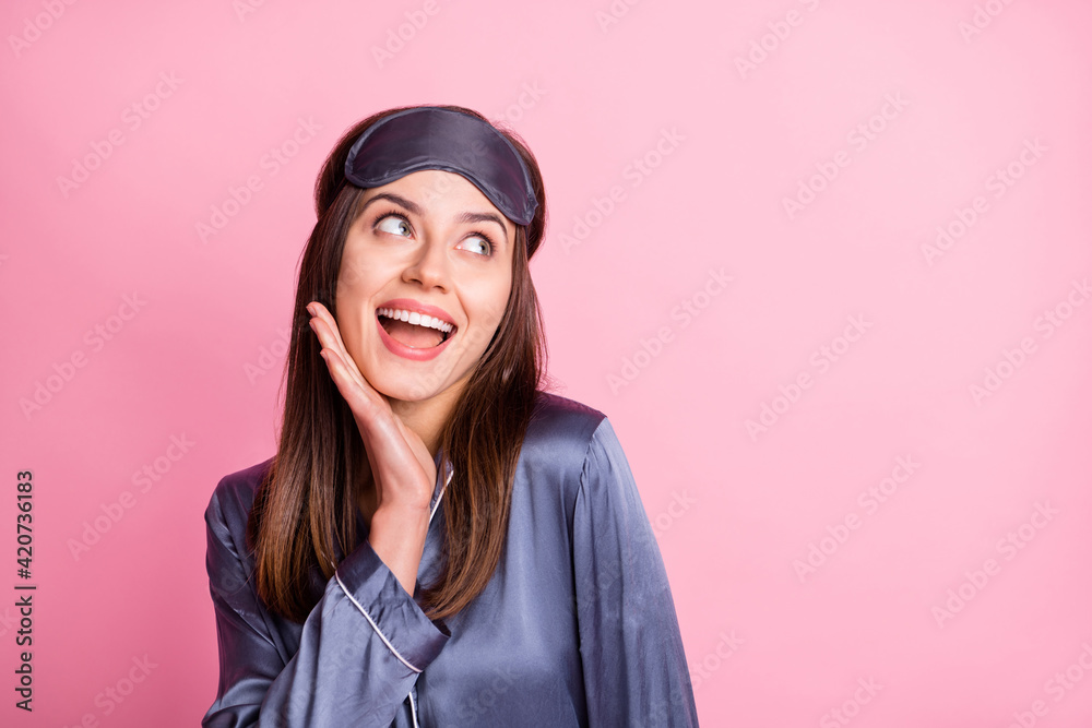 Photo portrait of cute girl touching face chin with hand looking at blank space isolated on pastel pink colored background Photo portrait of cute girl touching face chin with hand looking at blank space isolated on pastel pink colored background