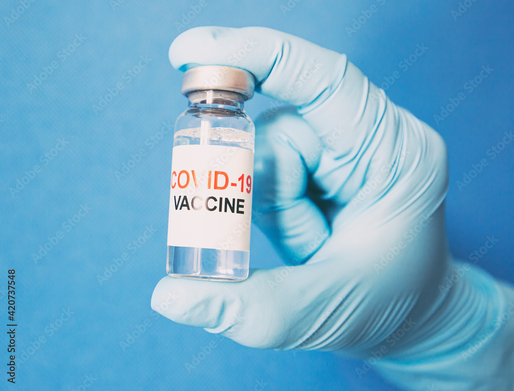 The nurse holding the covid 19 vaccine in hand The nurse holding the covid 19 vaccine in hand