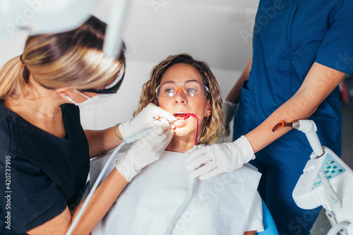 A Dentist Fixing a Patient's Tooth photo