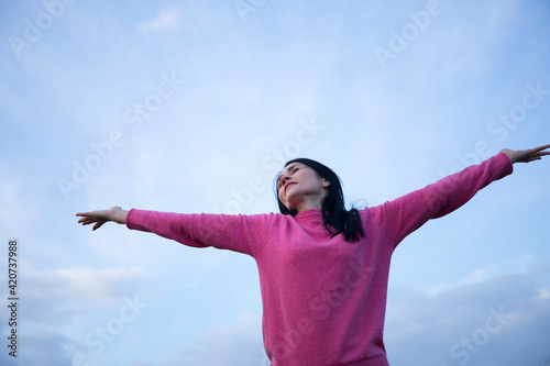 happy young woman enjoying freedom with open hands © Erika