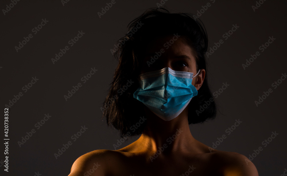 woman in mask. Dark. Shadow. Hope. Mask face. woman in mask. Dark. Shadow. Hope. Mask face.