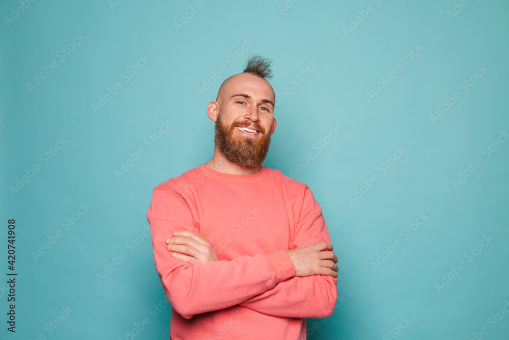 Bearded european man in casual peach isolated on turquoise background happy face smiling with crossed arms looking at the camera Bearded european man in casual peach isolated on turquoise background happy face smiling with crossed arms looking at the camera