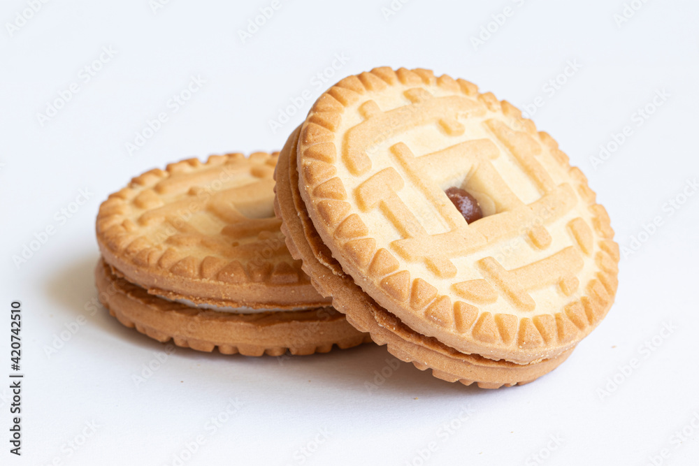 Delicious round cookies with strawberry filling on a light background. Delicious round cookies with strawberry filling on a light background.