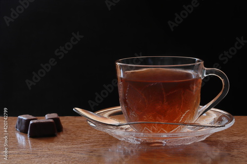 Tea in a transparent cup on a saucer.