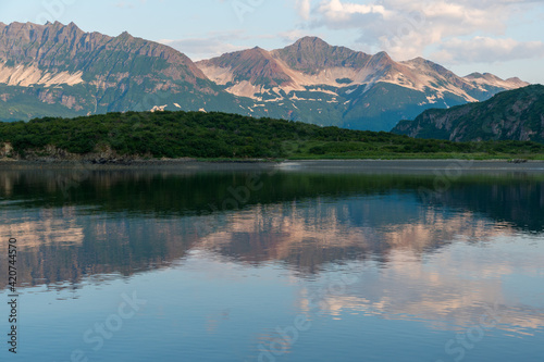 View of the coast and mountains of Geographic Harbor, Katmai, Alaska just after sunrise.