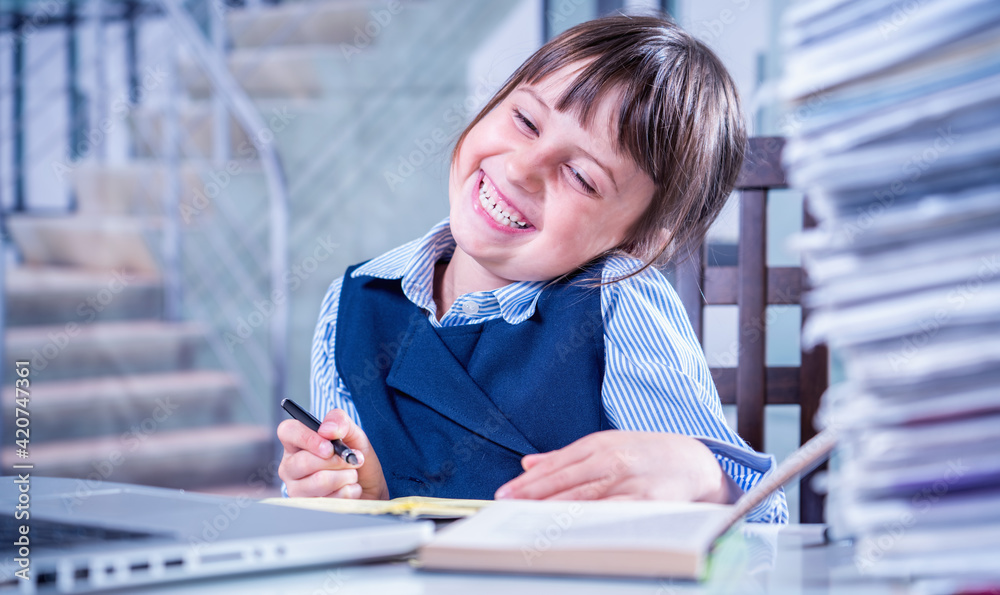 The path to success concept. Beautiful huppy business child girl learning and working at the same times.