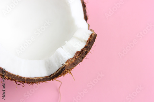Close-up coconut on a pink background with copy space. Advertising design, menu, packaging. 