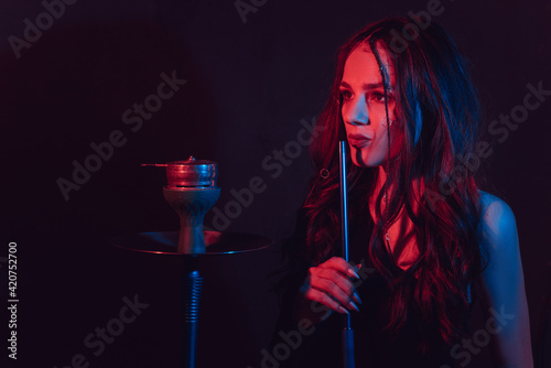 The theme of the hookah, sheesha. A young girl gets the pleasure of Smoking hookah