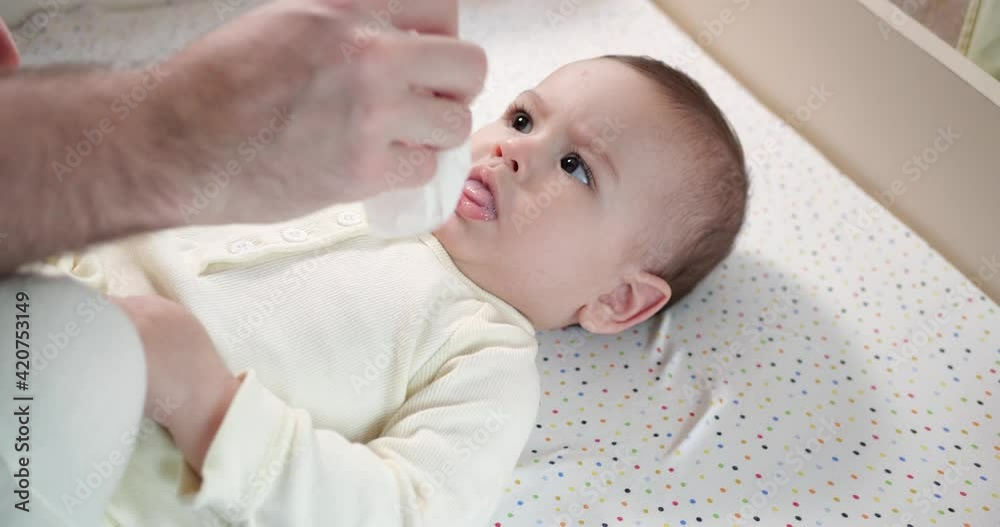 Caring father and baby are playing in the morning. Concept of baby, parenthood, childhood, maternity, Fatherhood. slow motion Caring father and baby are playing in the morning. Concept of baby, parenthood, childhood, maternity, Fatherhood. slow motion