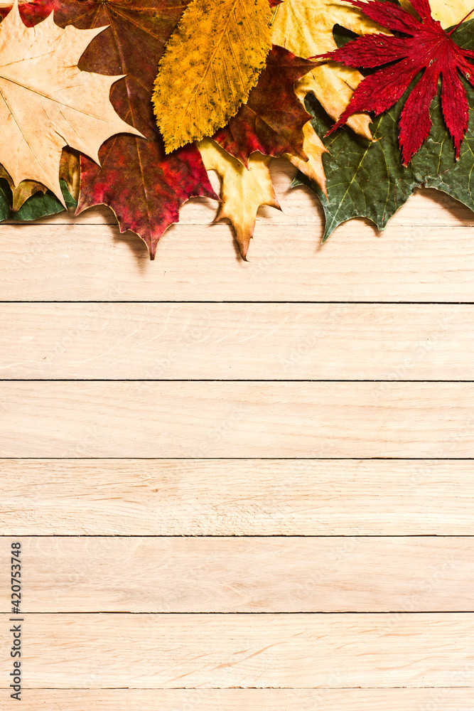 Autumn leaves on brown wooden background Autumn leaves on brown wooden background