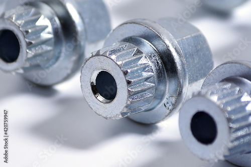Heads for wheel locks close-up on a white background. Macro shot of a set of wheel locks. The head for the wheels against the background of blurry locks for the wheels.