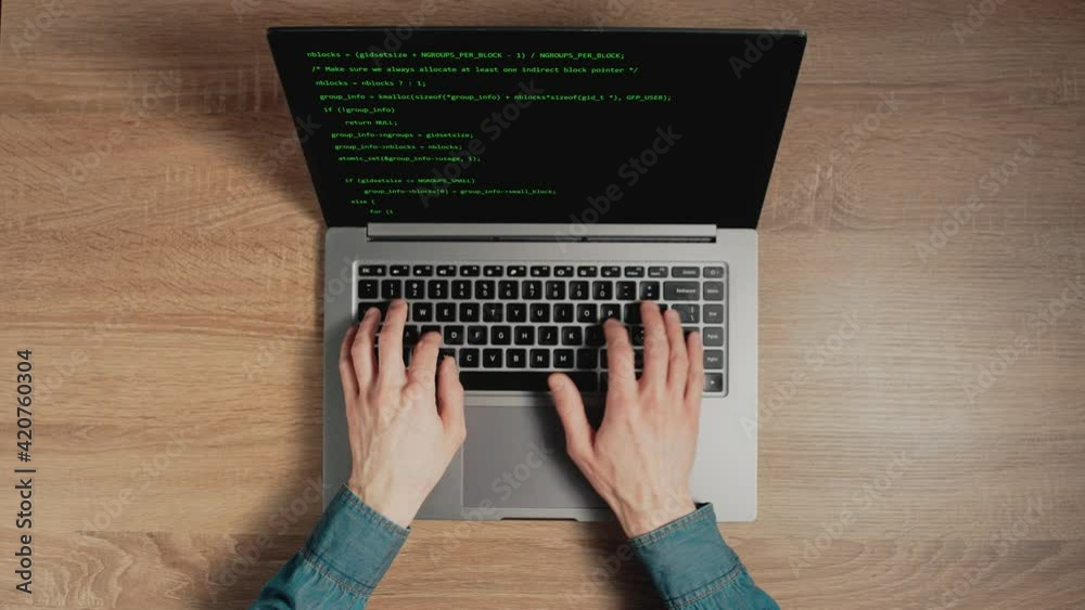 Closeup a man hands are typing commands of a laptop keyboard. A man is writing a program. The developer is coding. Code on the laptop screen. Concept of programming and development web. Closeup a man hands are typing commands of a laptop keyboard. A man is writing a program. The developer is coding. Code on the laptop screen. Concept of programming and development web.