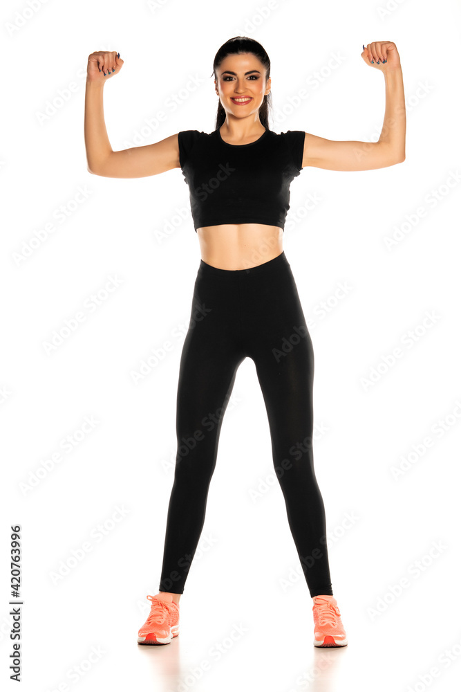 Front view of beautiful young sporty woman showing her arms Front view of beautiful young sporty woman showing her arms