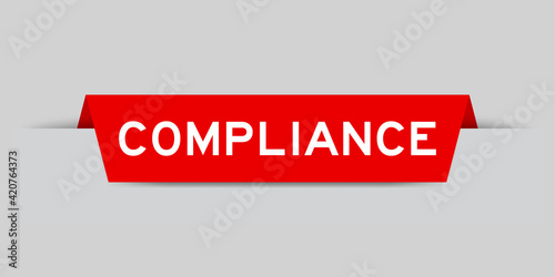 Red color inserted label with word compliance on gray background