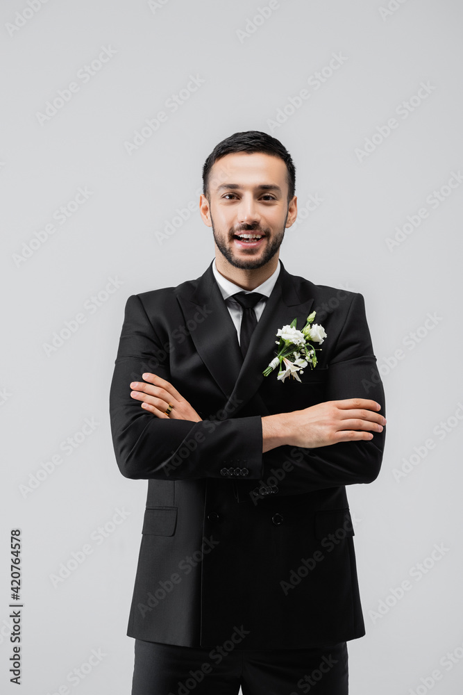 Happy muslim groom with crossed arms looking at camera isolated on grey Happy muslim groom with crossed arms looking at camera isolated on grey