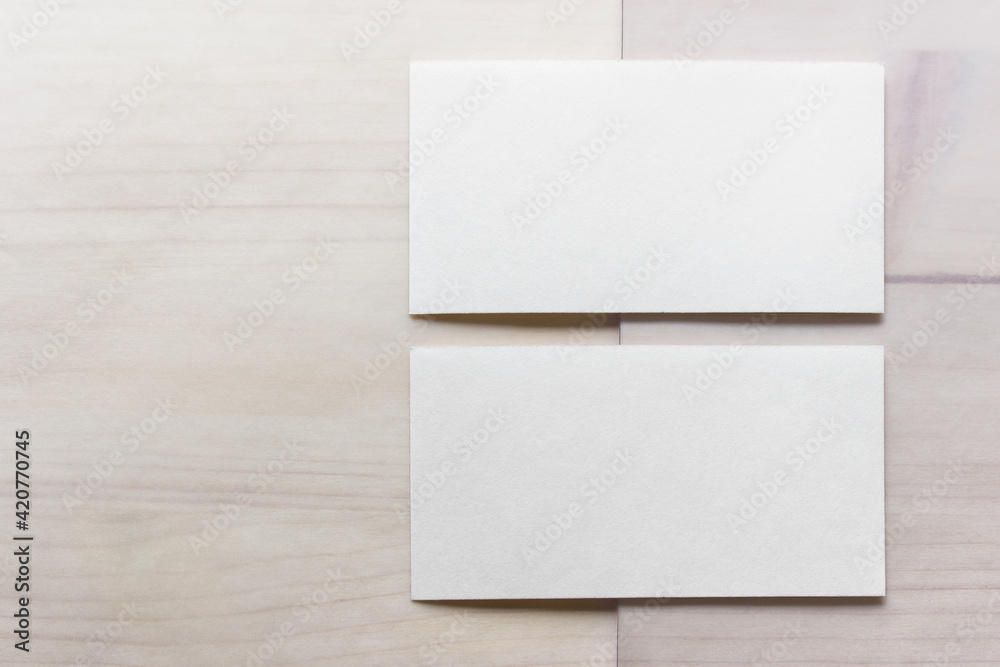 Mockup template with two blank business cards on wooden background. Mockup template with two blank business cards on wooden background.