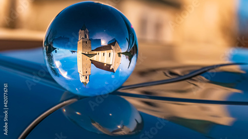 Crystal ball landscape shot with reflections on a car roof at Aholfing, Bavaria, Germany