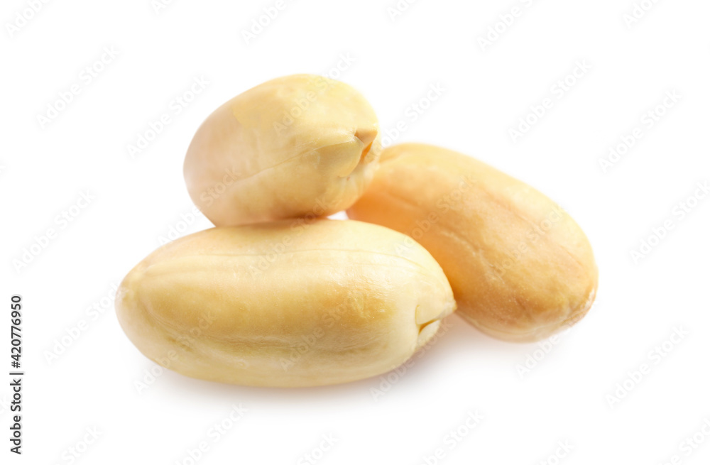 Few macro peeled peanuts isolated on white