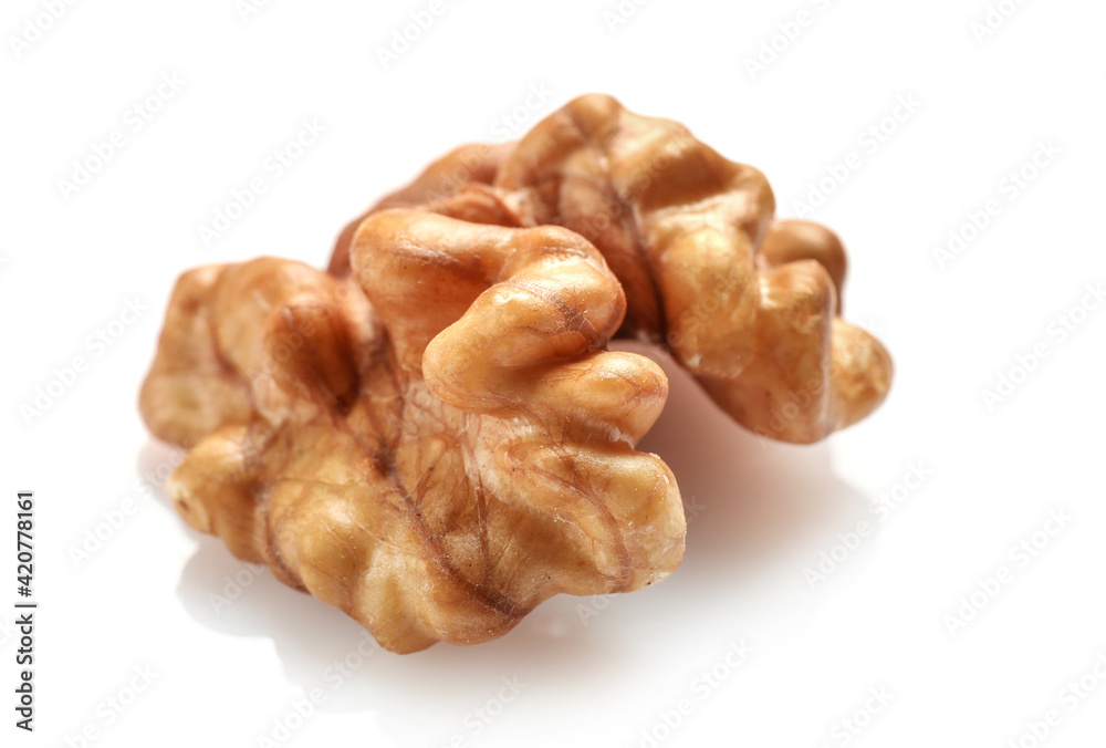 Single golden walnut kernel isolated on white Single golden walnut kernel isolated on white