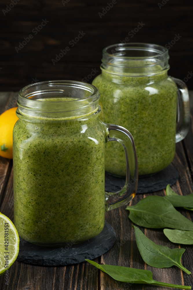 Healthy green smoothie with spinach in glass jars. Healthy green smoothie with spinach in glass jars.