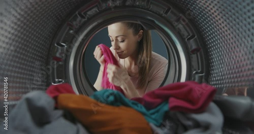 Woman smelling fresh soft laundry photo