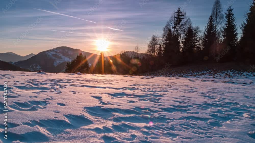 Beautiful nature sunset over forest and snowy meadow in cold winter evening Time lapse Beautiful nature sunset over forest and snowy meadow in cold winter evening Time lapse