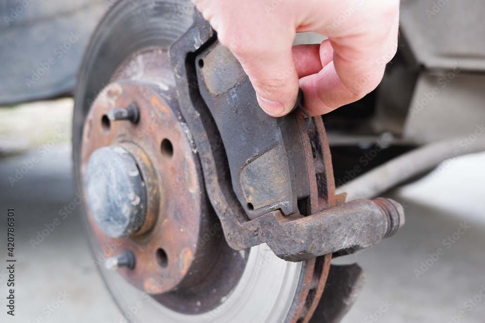 Car repair. Replacing the brake pads of disc brakes. Brake disc close-up. Car repair. Replacing the brake pads of disc brakes. Brake disc close-up.