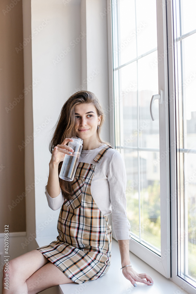 girl blogger drinks water during break