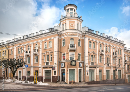 Residential building with a clock on the corner of Lenin and Bolshaya Sovetskaya streets in Smolensk © yulenochekk