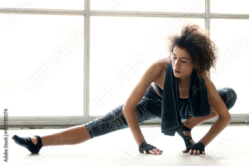 Young sporty woman is doing excercises and stretching