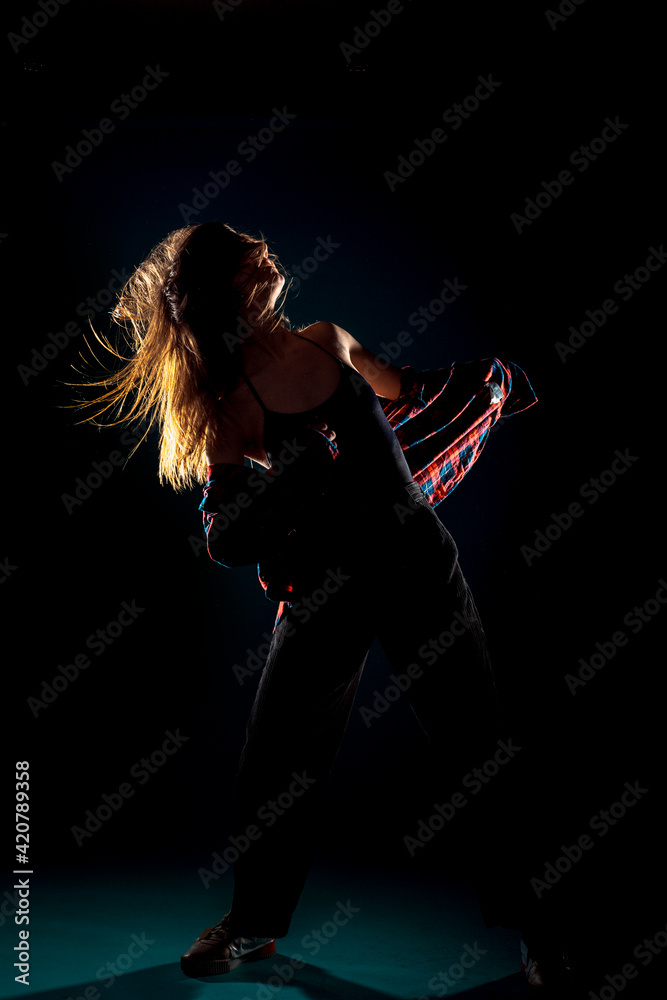 Modern style dancer  isolated on dark background