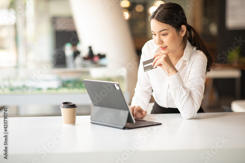 Portrait of Young woman using credit card and tablet for buying online shopping at home ,payment,buying and online shopping concept.