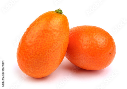 Two ripe juicy kumquat are isolated on a white background.