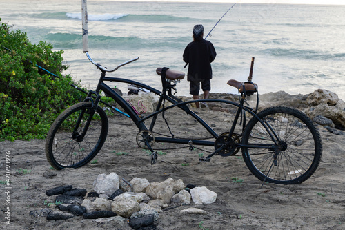 Mornings at a Hawaiian beach, people silhouetted, fishing, walking stretching.