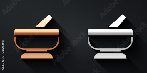 Gold and silver Mortar and pestle icon isolated on black background. Long shadow style. Vector