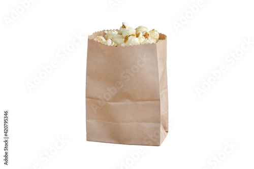 Sweet popcorn in a brown paper bag on white background.
