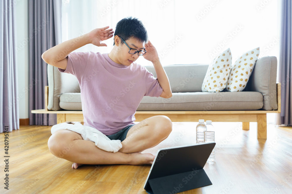 New normal Training At Home An Asian man, aged 35-40, with brown skin, Home exercise. exercising in living room. New normal Training At Home An Asian man, aged 35-40, with brown skin, Home exercise. exercising in living room.