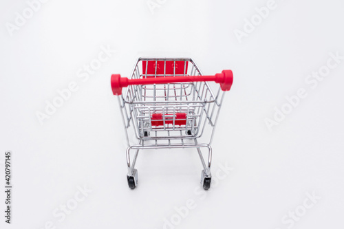Shopping cart on a white background, side view, copy space.