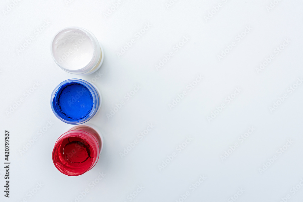 Gouache cans in the colors of the Russian flag, top view, close-up, white background, copy space Gouache cans in the colors of the Russian flag, top view, close-up, white background, copy space