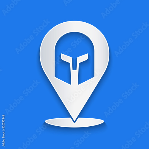 Paper cut Greek helmet icon isolated on blue background. Antiques helmet for head protection soldiers with a crest of feathers or horsehair. Paper art style. Vector