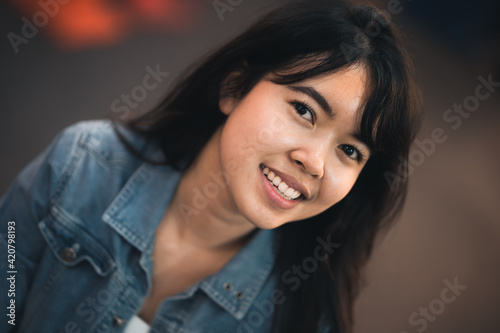 Beautiful Asian woman who has long hair travels to the festival at Yaowarat Chinatown in Thailand. Street photography of traveler woman at night. © amornchaijj