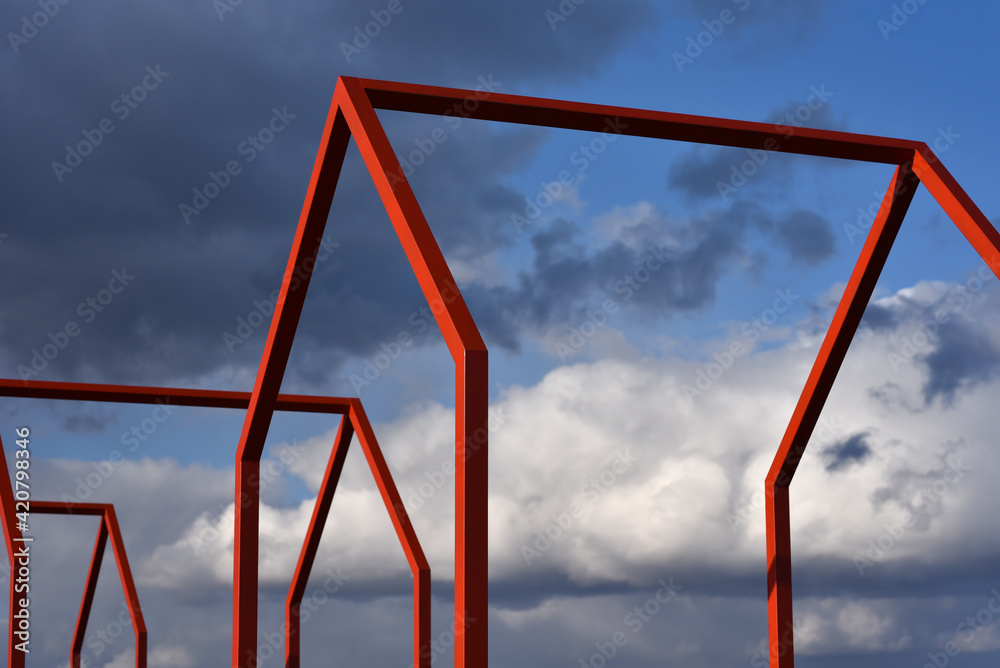 Metal frames of void houses without roofs and walls against the gloomy sky Metal frames of void houses without roofs and walls against the gloomy sky