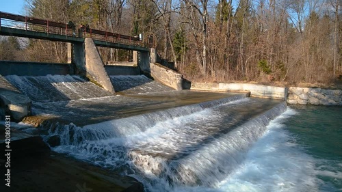 Concrete old spillway in forest with flowing water. Abandoned river dam. Rural water retention dam. Old power plant. Static shot, real time