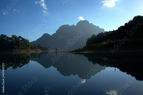 Landscape cheow Lan Lake with shadow of Mountains in Khao Sok National Park in Surat Thani Province, Southern Thailand
