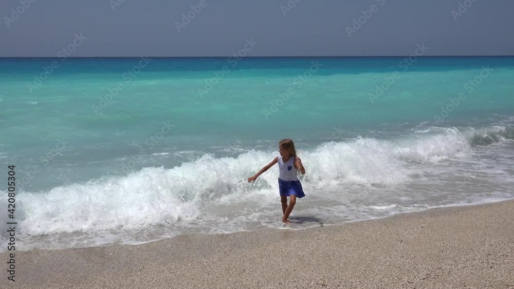 Girl Playing on Beach, Kid Running on Seashore at Sunset, Little Child Watching Sea Waves on Coastline Shore in Summer Vacation Girl Playing on Beach, Kid Running on Seashore at Sunset, Little Child Watching Sea Waves on Coastline Shore in Summer Vacation