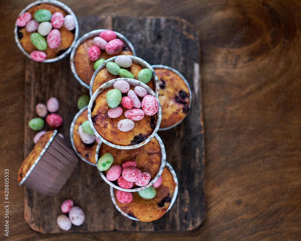 Cupcakes decorated with Easter chocolate eggs. Wooden background. Top view
Cupcakes decorated with Easter chocolate eggs. Wooden background. Top view