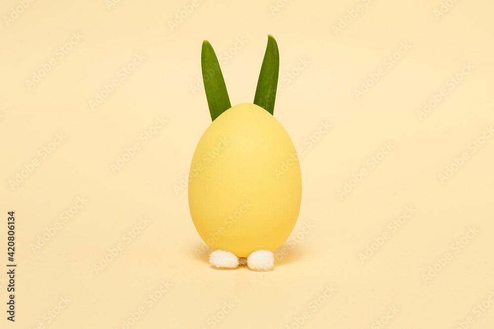Easter egg with bunny ears on a yellow background. Flat lay. Easter egg with bunny ears on a yellow background. Flat lay.